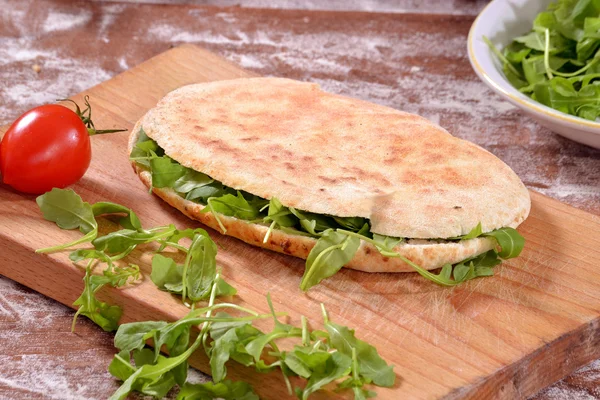 Sandwich with arugula on board — Stock Photo, Image