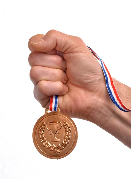 Mano sosteniendo medalla de oro — Foto de Stock