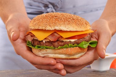 Cook hands holding  hamburger