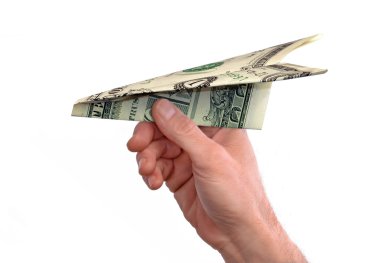 Hand throwing a dollar paper plane