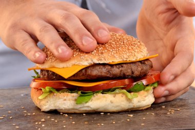hands holding and preparing hamburger.