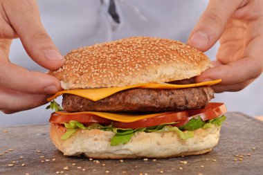 hands holding and preparing hamburger.