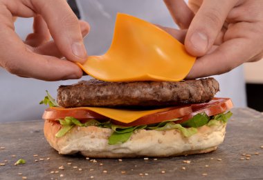 hands holding and preparing hamburger.