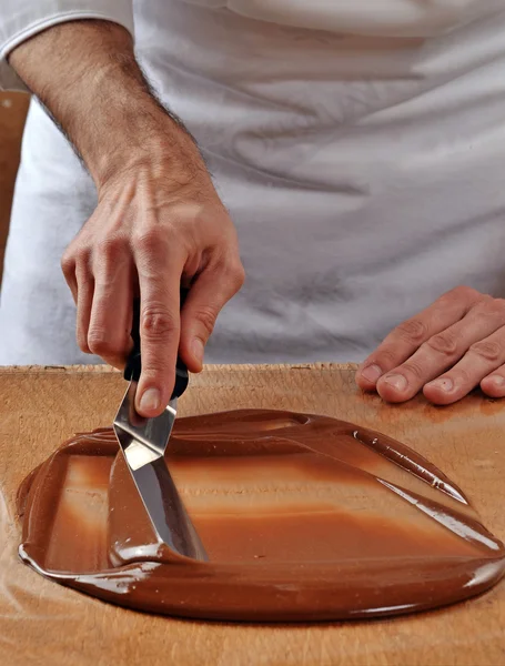 Cook mixing chocolate cream — Stock Photo, Image