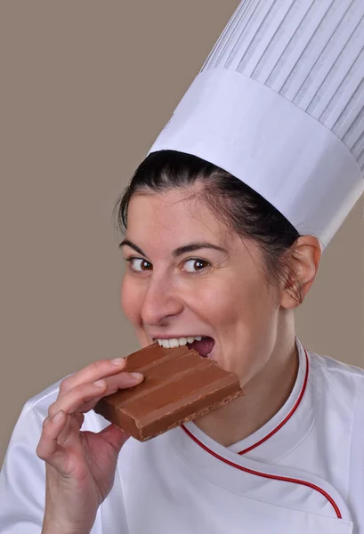 Woman biting chocolate bar. — Stock Photo, Image