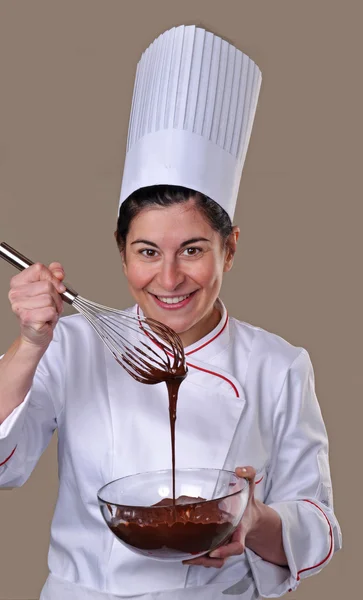 Cook woman tasting chocolate cream — Stock Photo, Image
