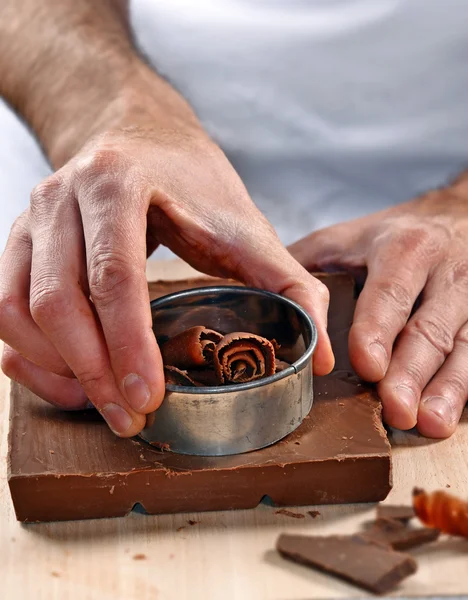 Les mains tranchant du chocolat frais — Photo