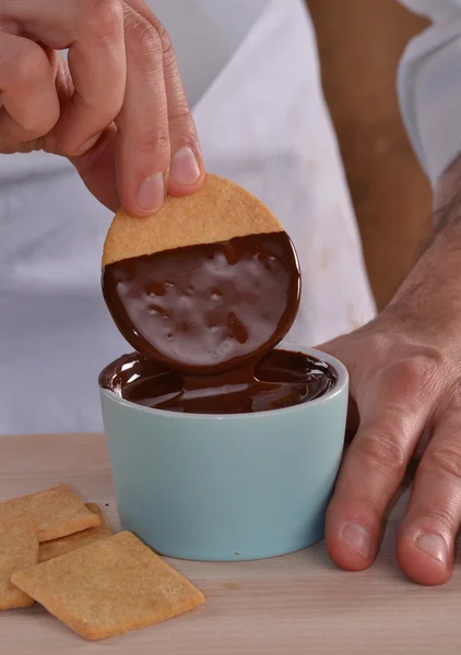 초콜릿 크림에서 쿠키를 간직 하는 손. — 스톡 사진