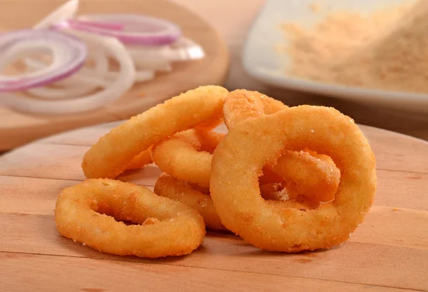 Onion rings on wood table — Stock Photo, Image