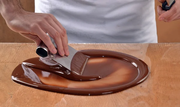 Cook mixing chocolate cream — Stock Photo, Image