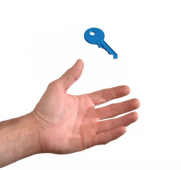 Hand catching a blue key — Stock Photo, Image