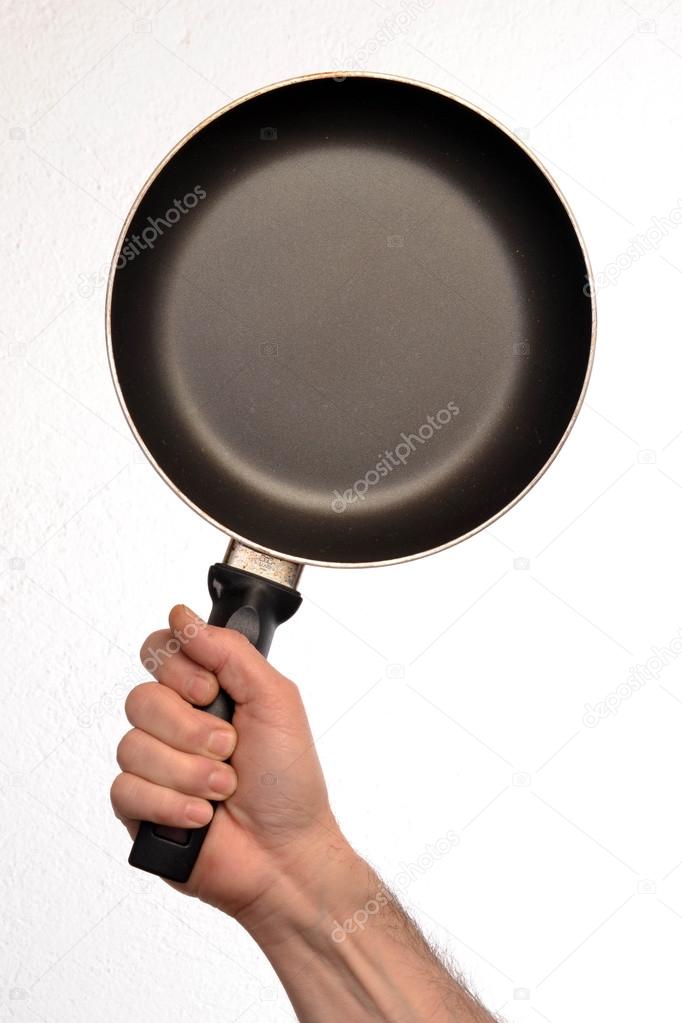 Hand holding a pan