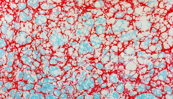 Красно-синяя белопятнистая эбру — стоковое фото
