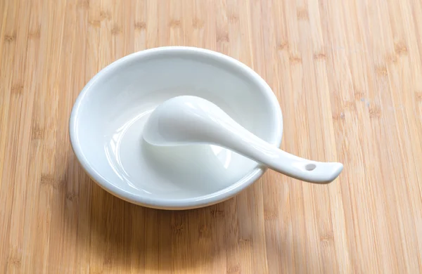 White cup and spoon with bamboo texture surface