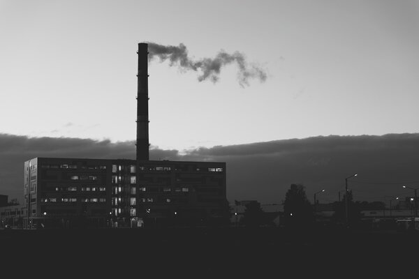 Smoke from pipe in the evening in black and white