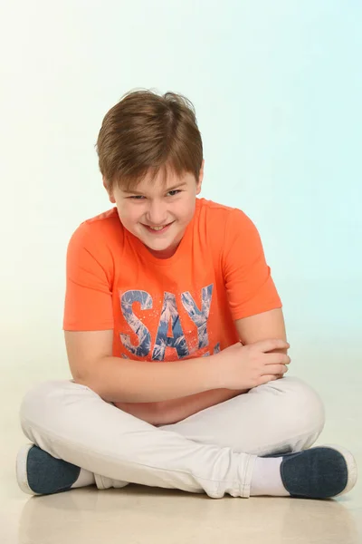 Handsome Fashionable Developed Cheerful Teenage Boy Orange Shirt Sits Cross — Stock Photo, Image