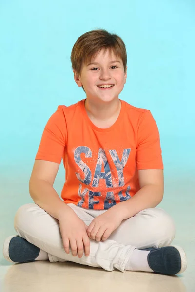 Handsome Fashionable Developed Cheerful Teenage Boy Orange Shirt Sits Cross — Stock Photo, Image