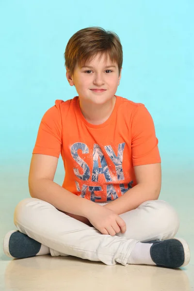 Handsome Fashionable Developed Cheerful Teenage Boy Orange Shirt Sits Cross — Stock Photo, Image