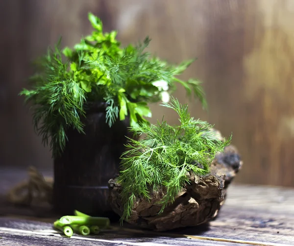 Bouquet of fragrant herbs of fennel and parsley, on a wooden background, rural style, selective focus    design, effects, toning