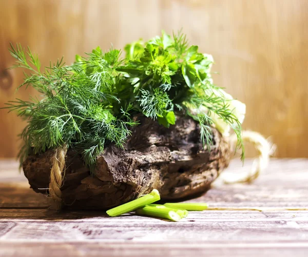 Bouquet of fragrant herbs of fennel and parsley, on a wooden background, rural style, selective focus    design, effects, toning