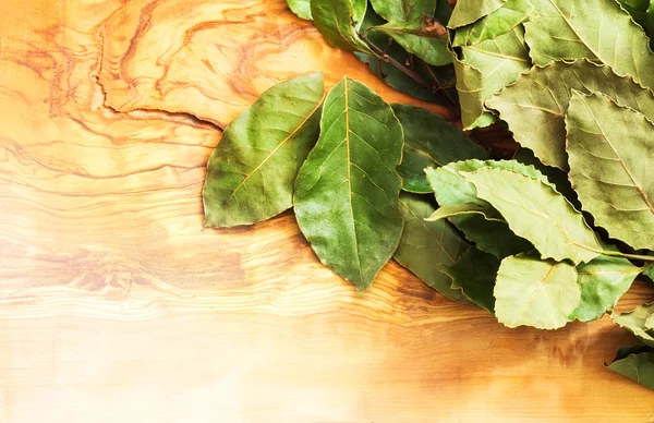 Green bay leaf on wooden texture