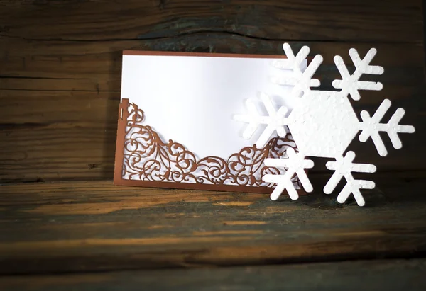 Copos de nieve con un sobre de encaje marrón — Foto de Stock