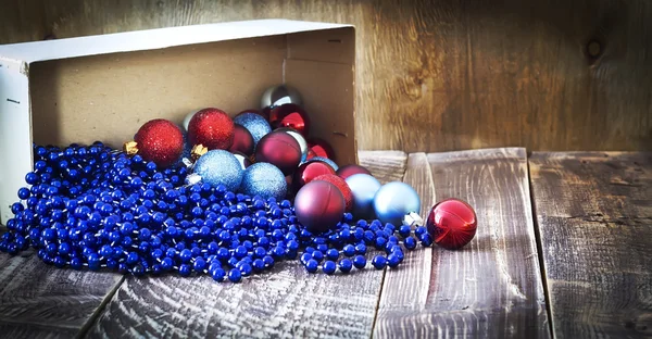 Box with Christmas tree decorations, garland — Stock Photo, Image