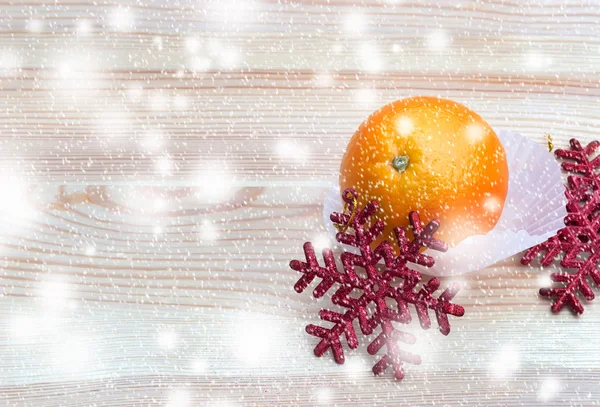 Bright orange with snowflakes on wooden texture — Stock Photo, Image