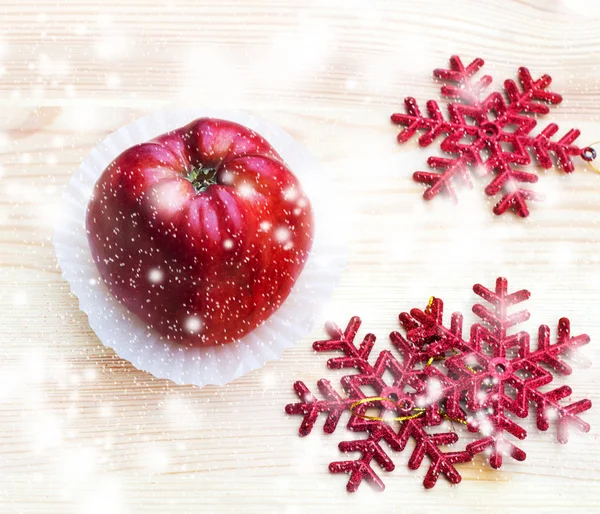 Apple with snowflakes on wooden texture, selective focus — Stock Photo, Image