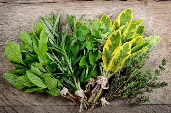 Bunch of fresh herbs wooden background. — Stock Photo, Image