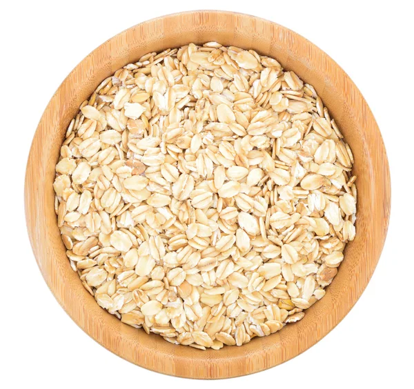 Rolled oats in wooden bowl isolated. — Stock Photo, Image