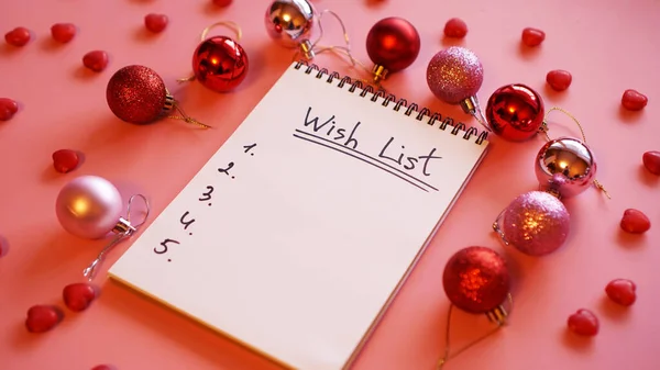Notebook on pink background with christmas balls — Stock Photo, Image