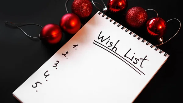 Notebook on black background with christmas balls — Stock Photo, Image