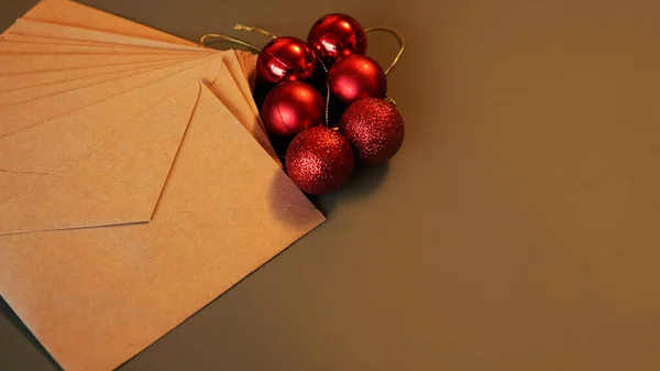 Christmas composition. Craft envelopes and red balls — Stock Photo, Image