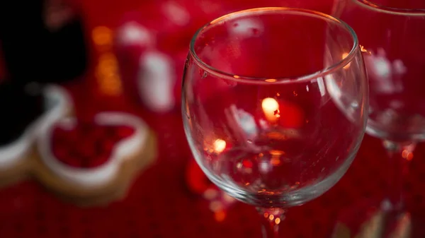 Empty wine glass on love dinner, candle on red background — Stock Photo, Image