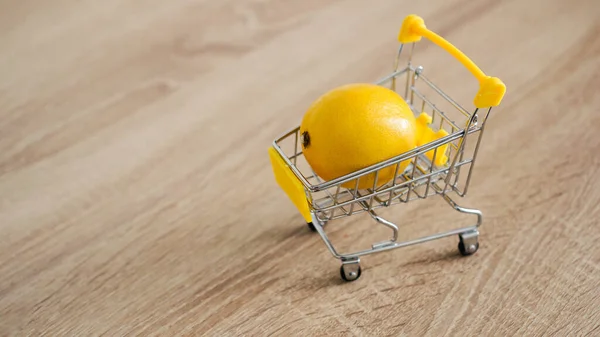 Citron v supermarketu vozíku na kuchyňském pozadí. Koncept nakupování online — Stock fotografie
