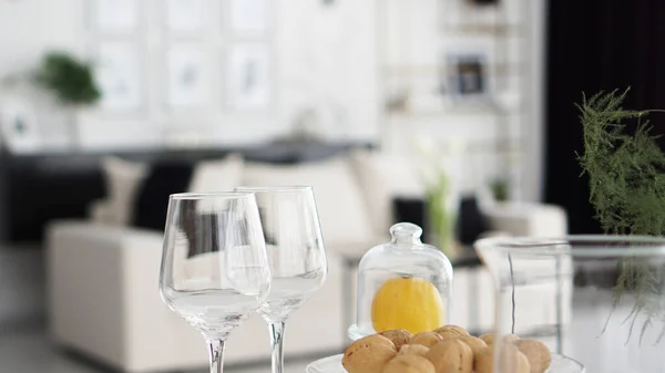Empty wine glasses on blurred background of modern interior — Stock Photo, Image