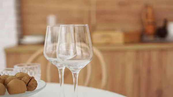 Empty wine glasses on wooden interior of modern kitchen. Scandinavian style — Stock Photo, Image