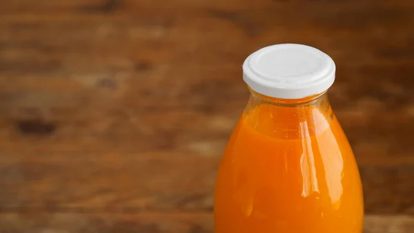 Juice bottle on wood background - Fresh orange juice