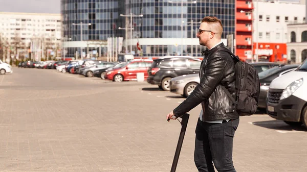 Modern man riding electric scooter in the city