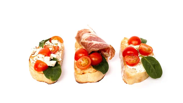 Three bruschetta on a ciabatta on a white plate. Italian appetizer — Stock Photo, Image