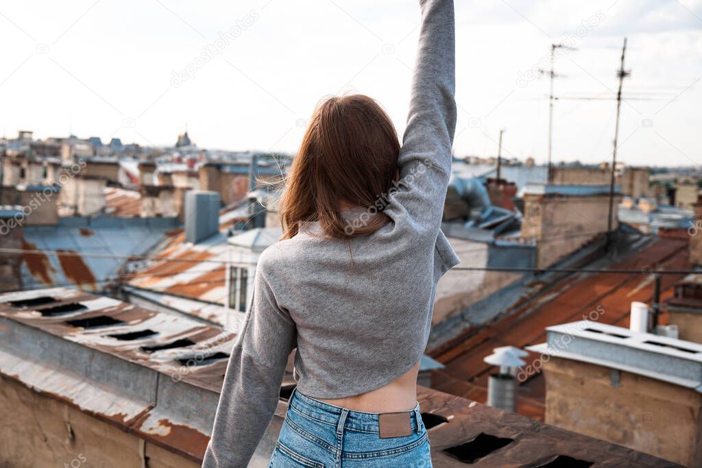 Woman is happy on the roof of Saint Petersburg, Russia