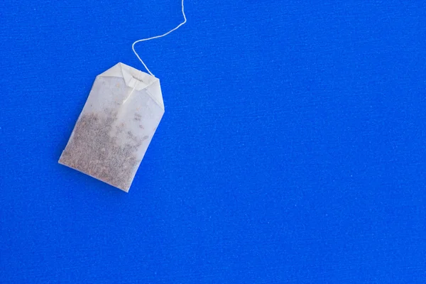 Tea bag on a blue background — Stock Photo, Image