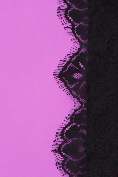 Erotic black lace on a pink background — Stock Photo, Image