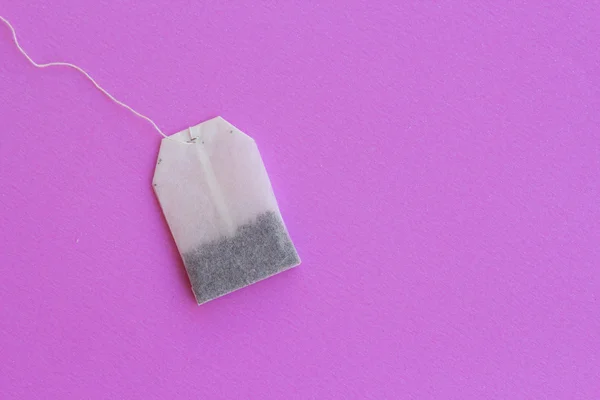 Tea bag egy rózsaszín háttér — ingyenes stock fotók