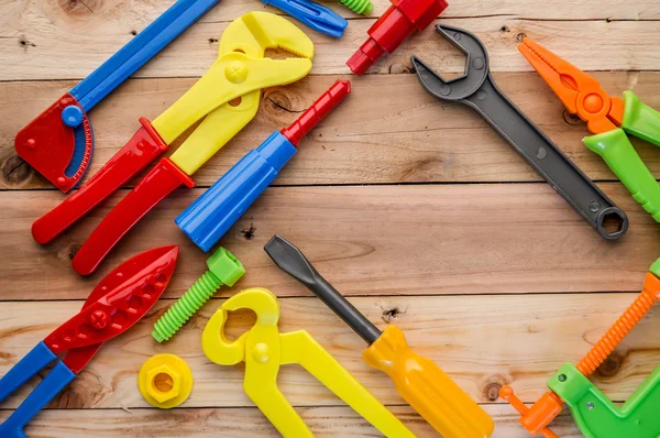 Tools and instruments toys on wood texture — Stock Photo, Image