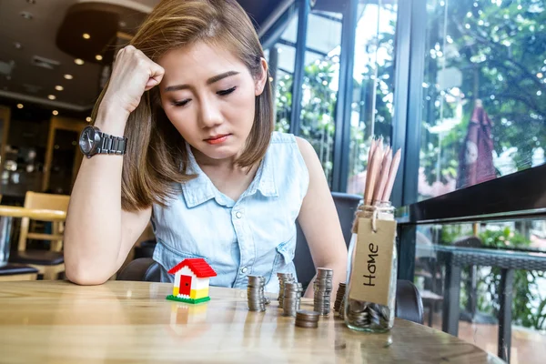 asia woman with house model and money