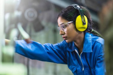 portrait asian female Professional engineering wearing uniform and safety goggles Quality control, maintenance, monitor screen checking process in factory, warehouse Workshop for factory operators clipart