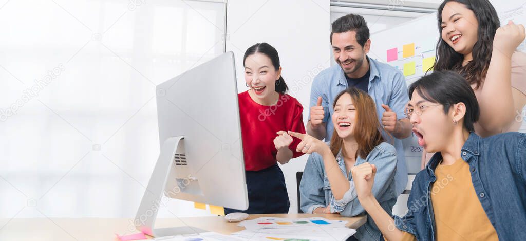 Inspire your teamwork to keep on achieving Group of Asian team creative business people hand raise up partnership teamwork concept infornt of monitor screen modern office background