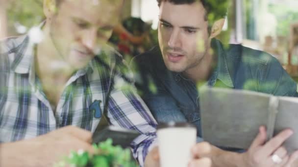 Dos socios de negocios consultan estrategia de negocio con la felicidad de mano en el fondo de café cerca de la ventana — Vídeos de Stock